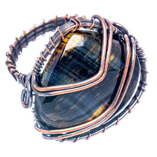 Copper wire wrap ring featuring dark blue tiger's eye centerpiece with multiloop band