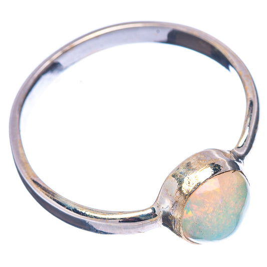 Oval opal cabochon set in a sterling silver band ring, side view