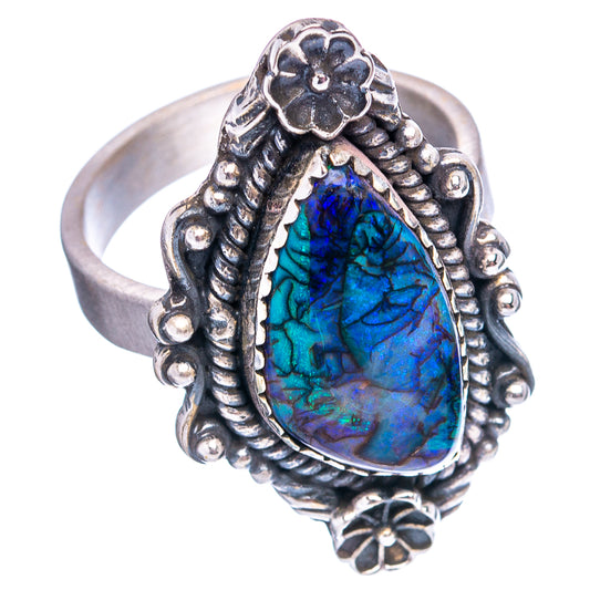 Sterling silver opal ring with blue teardrop cabochon, flower top, and textured shank