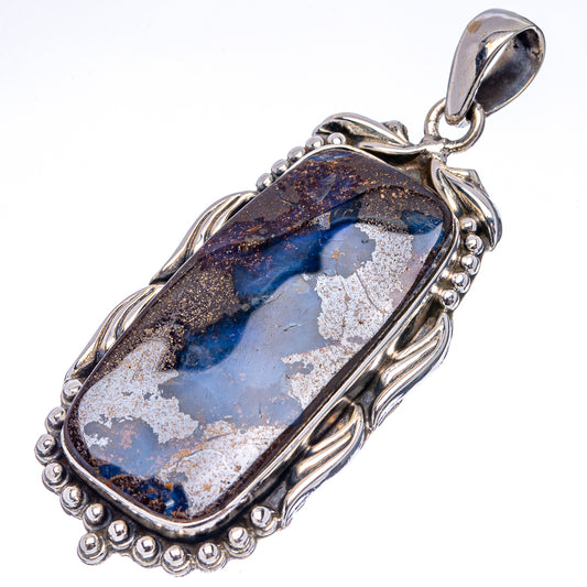 Sterling silver boulder opal pendant with blue, white, and dark stone in ornate oval frame