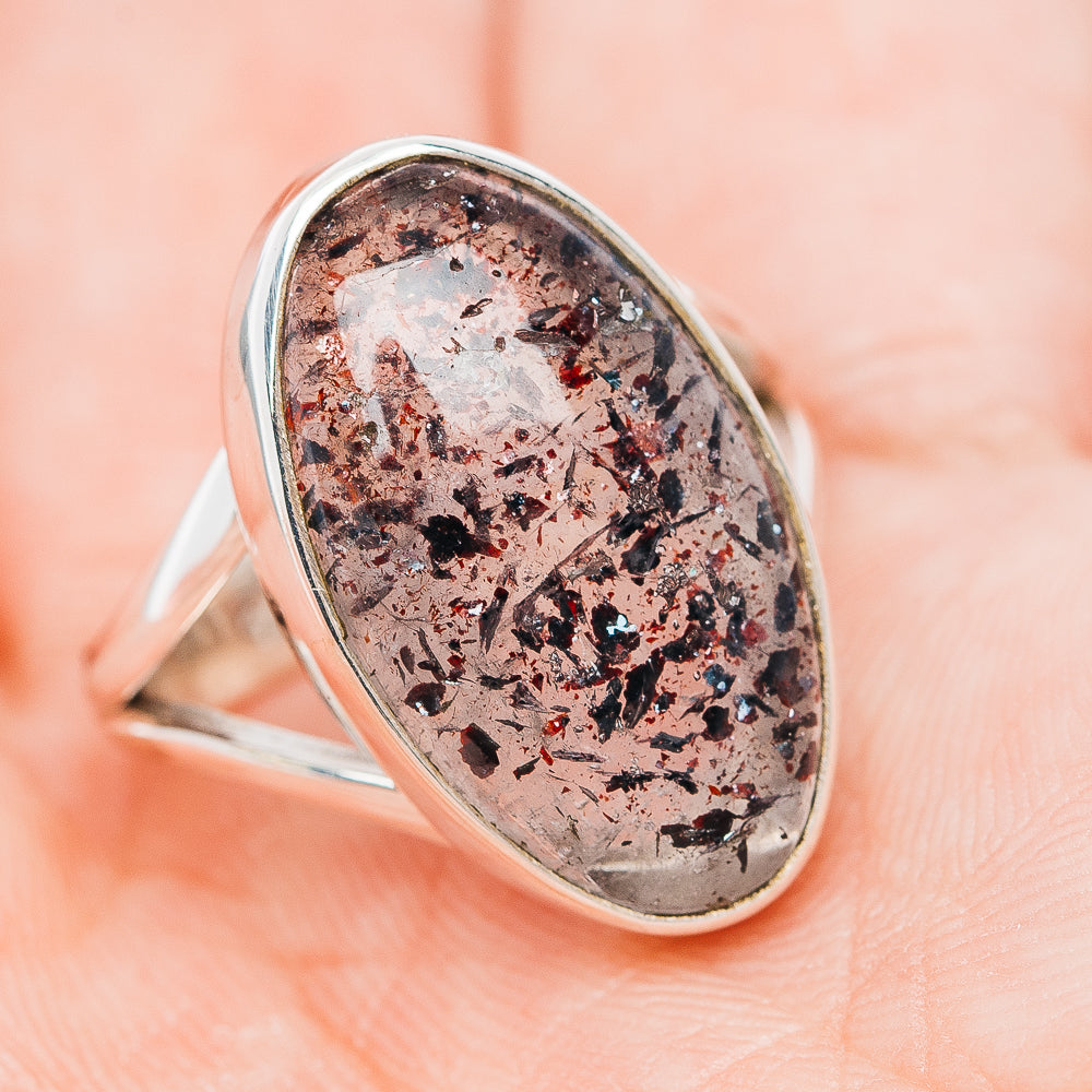 Sterling silver oval ring with mottled dark-and-rust speckled stone, side view