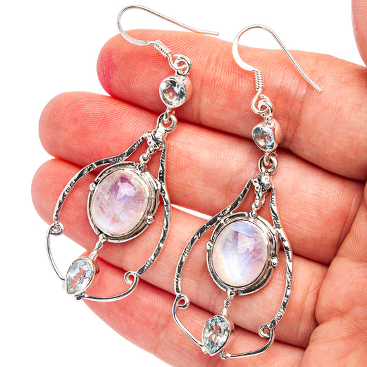 Sterling silver oval moonstone drop earrings with blue topaz stones and curved hoops