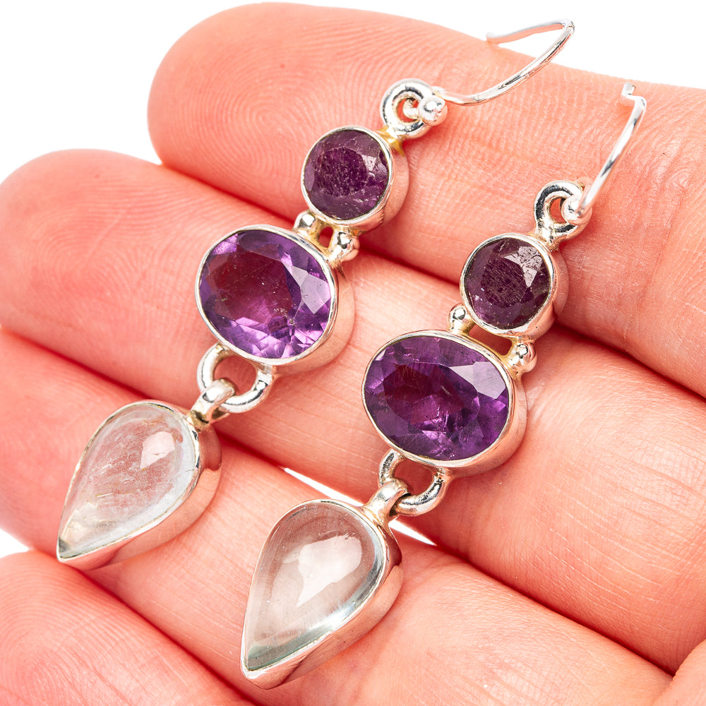 Sterling silver drop earrings with faceted amethyst purple stones and clear pear accents