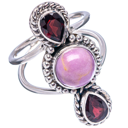 Sterling silver ring with oval purple center cabochon and two dark red faceted stones