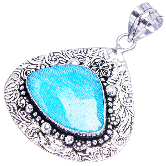German silver onyx pendant with blue teardrop center and ornate filigree frame