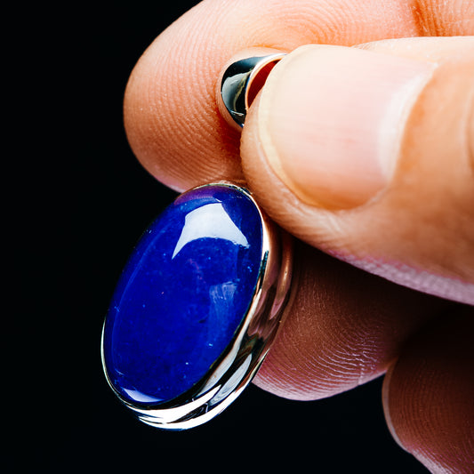 Oval blue tanzanite pendant close-up on sterling silver bail and bezel