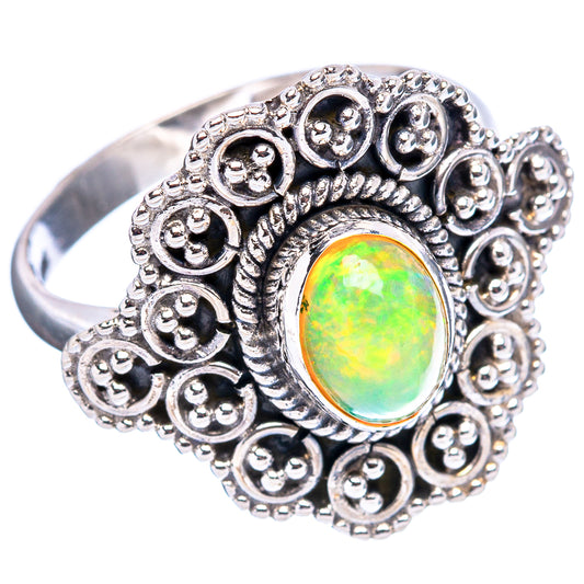 Sterling silver opal ring with round-edged filigree and oval green-yellow gemstone bezel