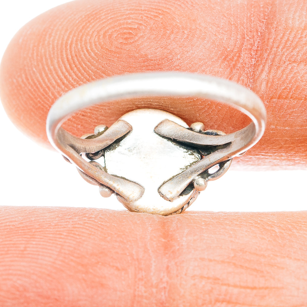 Sterling silver ring band with engraved leaf-like cutout design under setting