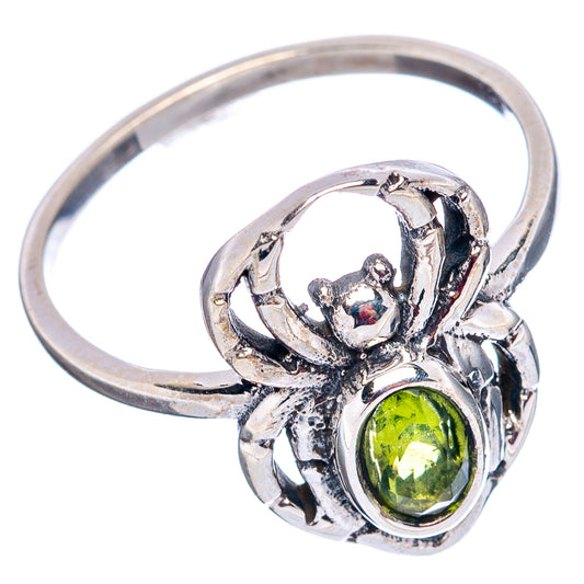 925 sterling silver spider ring with round peridot-green gemstone, openwork filigree.