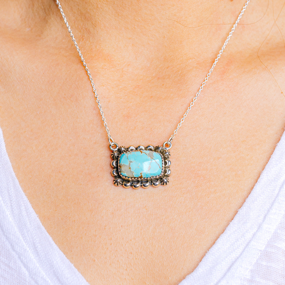 Sterling silver turquoise pendant necklace with ornate square bezel and link chain