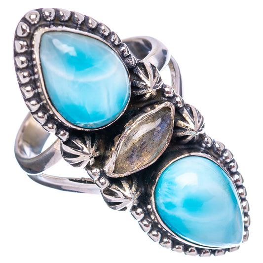 Sterling silver ring with two oval light-blue stones and engraved star-like accents