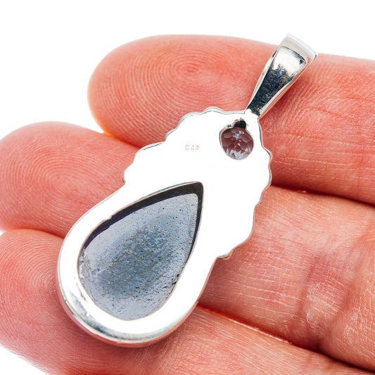 Sterling silver pendant back with .925 hallmark, blue teardrop stone, small round gem