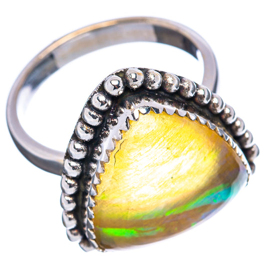 Sterling silver opal ring, beaded halo around a yellow-to-green pear gem, side view