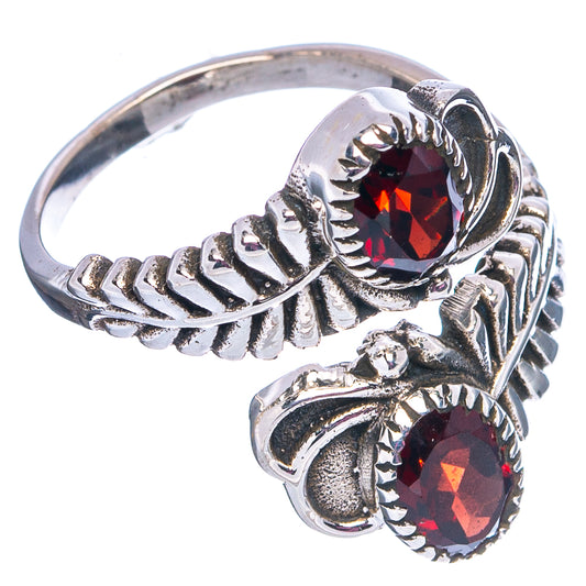 Silver ring with two faceted garnet stones and engraved leaf-like metalwork