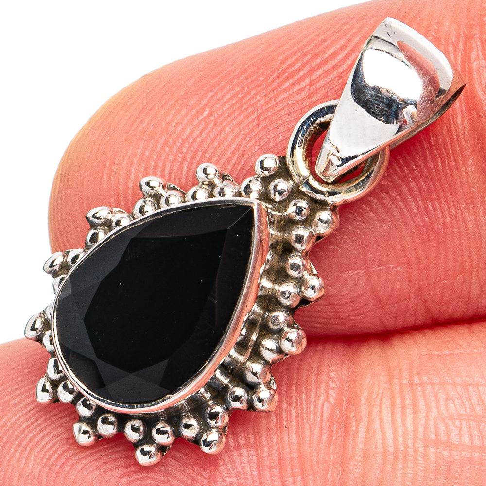 Sterling silver pendant with faceted black onyx teardrop center and ornate bezel