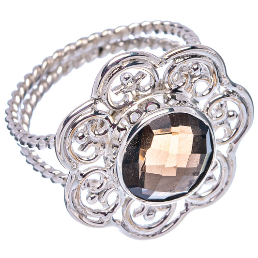 Sterling silver ring with dark faceted oval gemstone, filigree scrolls and textured band