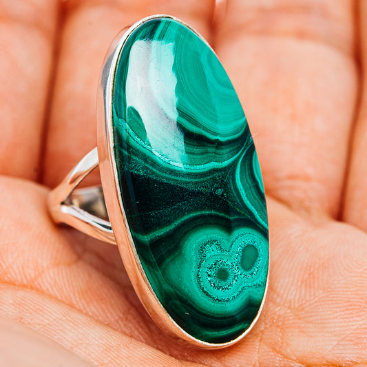 Oval malachite gemstone ring with silver band, dark green and turquoise swirling stone