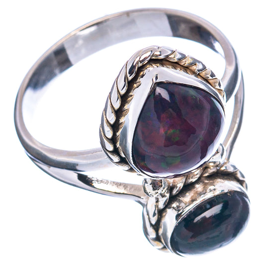 Oval black opal ring with twisted bezel and double-stone setting in .925 silver