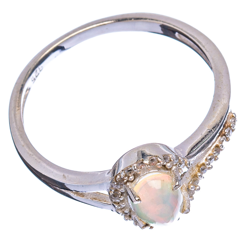 Oval opal-style gemstone ring with cubic zirconia halo on sterling silver band