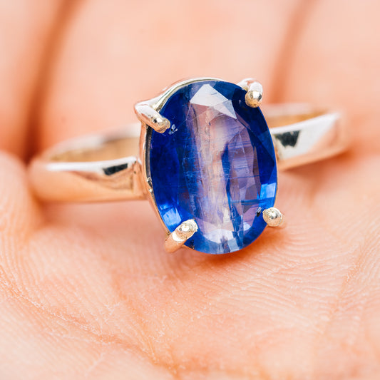 Oval faceted kyanite sterling silver ring with blue stone and four corner prongs