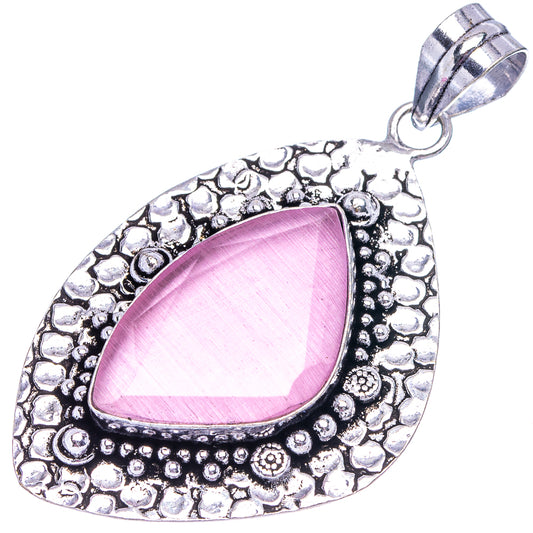 Pink onyx teardrop pendant with textured German-silver frame and hanging loop