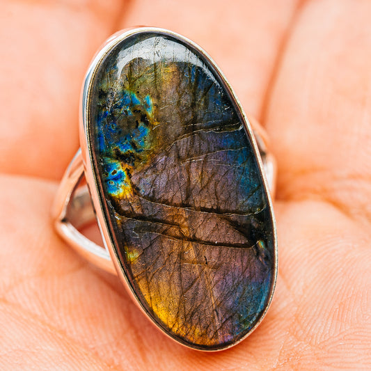 Oval labradorite cabochon ring with .925 sterling silver band, blue-gold flash side view