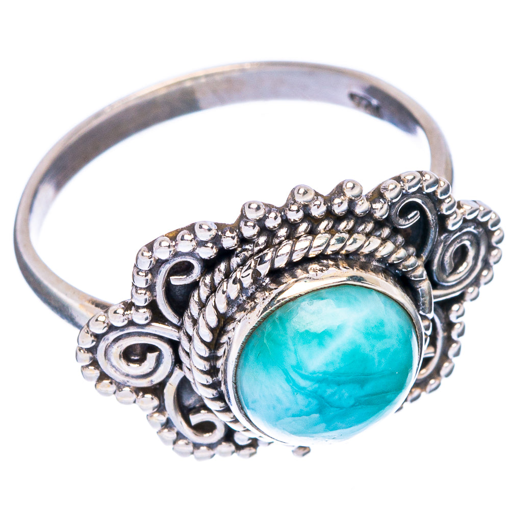 Sterling silver ring with blue oval stone, textured bezel and beaded halo