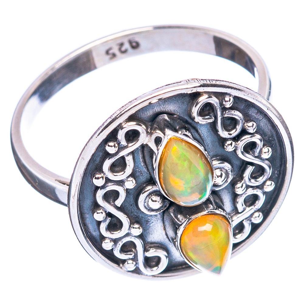 Silver back view of ring with ornate scroll setting and two opal cabochons, green-orange.