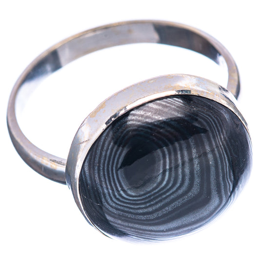Size 10 .925 sterling silver ring with dark round psilomelane cabochon, angled view.
