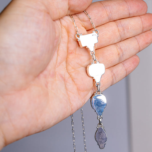 Sterling silver charm necklace with multiple dangling teardrop pendants