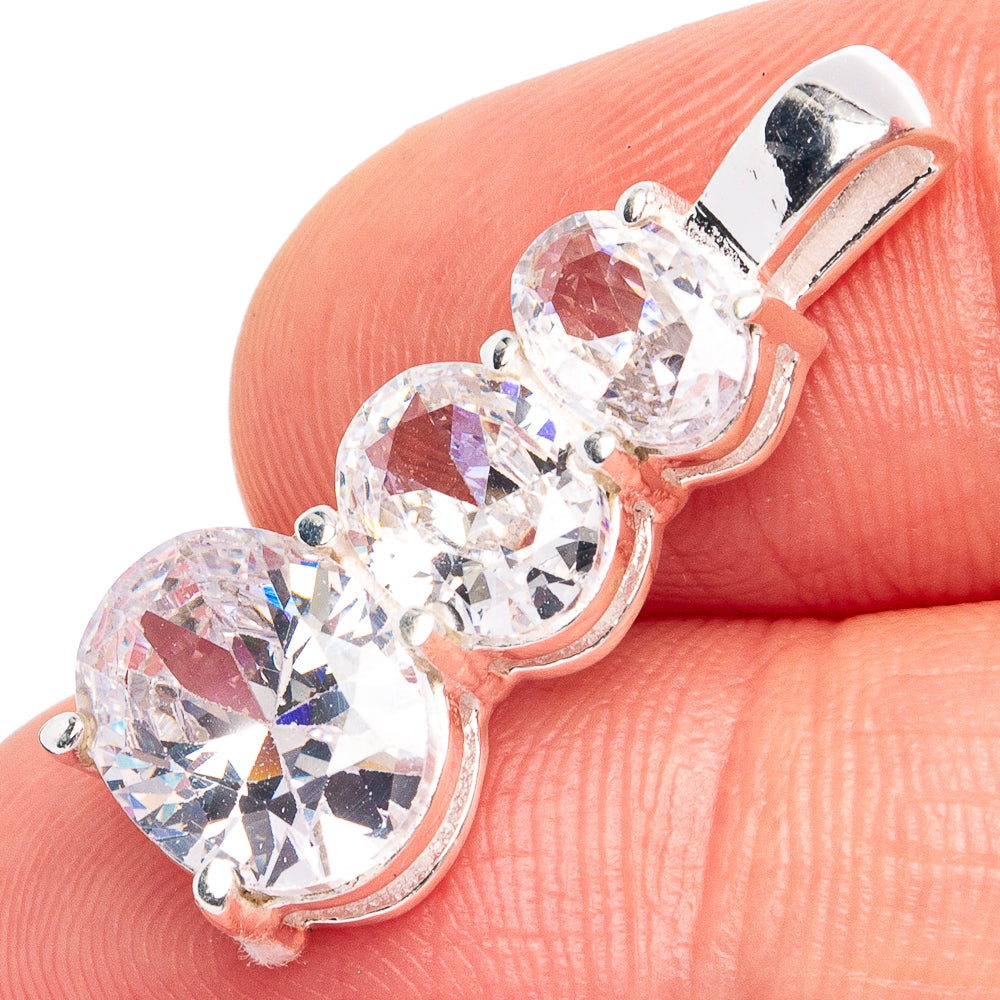 Dainty sterling silver pendant with three round white quartz stones in linked prong setting