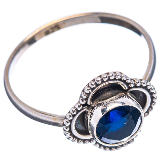Sterling silver ring with round dark blue gemstone, prong setting and beaded border