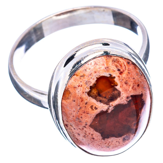 Sterling silver ring with oval fire opal, angled side view showing band