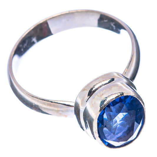 Blue faceted gemstone ring with .925 sterling silver band, round setting and blue stone