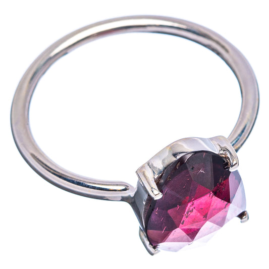 Sterling silver ring with maroon faceted garnet in square-prong setting, side view