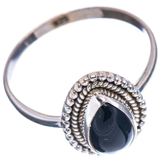 Silver onyx ring with ornate beaded halo and dark oval gemstone, band visible
