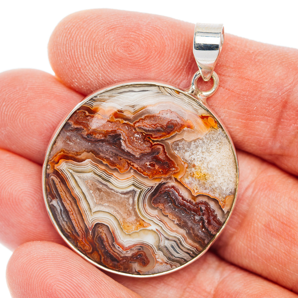 Round crazy lace agate pendant in .925 sterling silver bezel, multicolor bands.