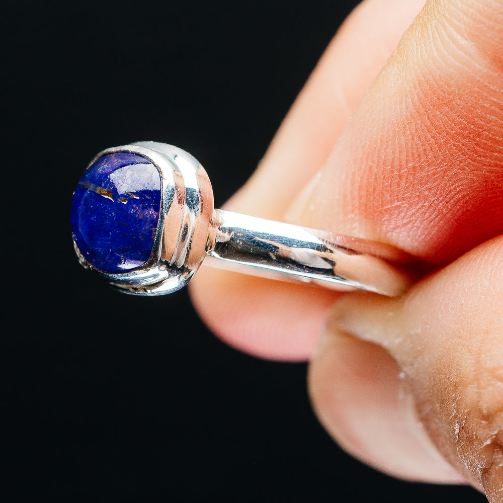 Sterling silver tanzanite ring with oval blue gemstone, bezel set on band
