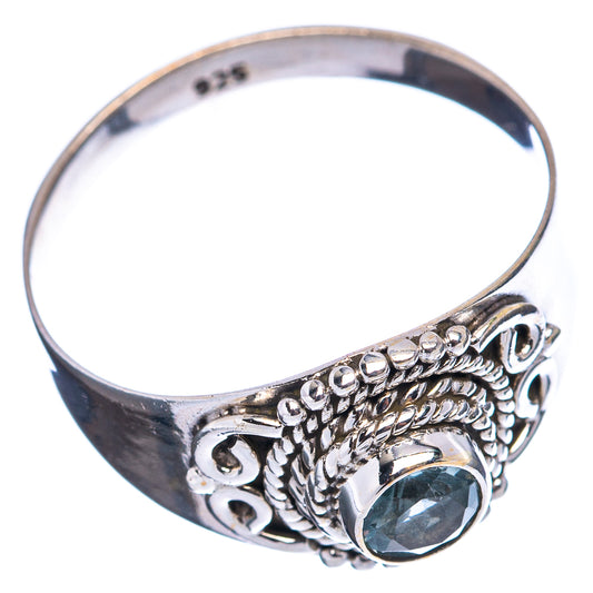Sterling silver ring with blue topaz stone, decorative side scrollwork