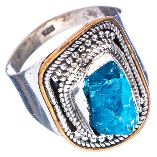 Sterling silver apatite ring with oval blue stone, decorative filigree, and gold-tone edge.