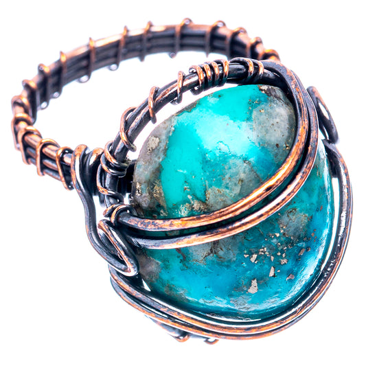 Oxidized copper turquoise wire wrap ring with oval stone, angled view