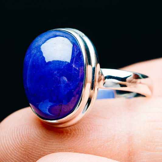 Sterling silver oval tanzanite-style ring showing side setting and blue gemstone on finger