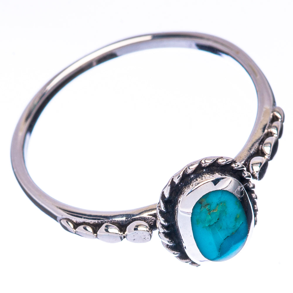 Sterling silver ring featuring an oval turquoise cabochon with beadlike bezel border