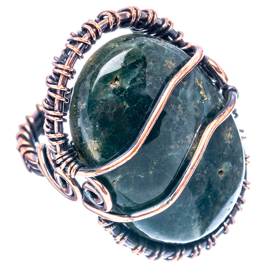 Oxidized copper wire-wrap ring featuring oval green gemstone with copper frame