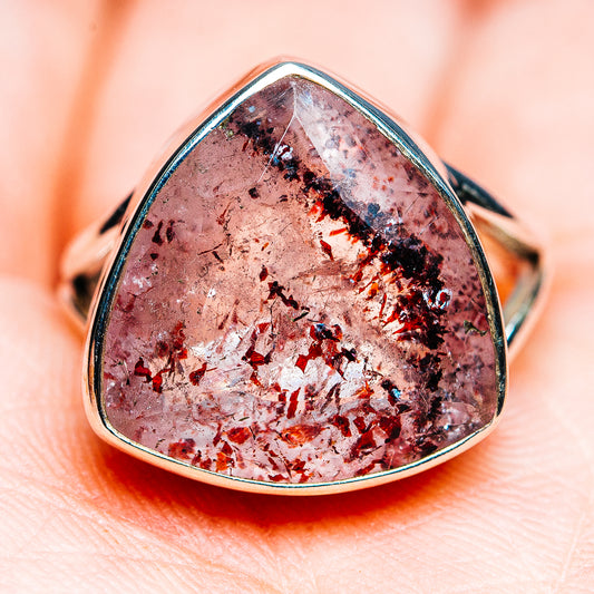 Teardrop lepidocrocite ring with pink, silver, and dark flecked stone in silver band