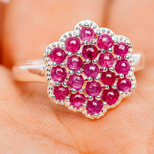 Sterling silver ruby flower cluster ring with pink-red round stones and green bead accents