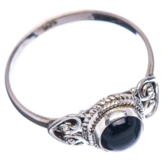 Sterling silver ring with black onyx cabochon, twisted edge and decorative side scrolls