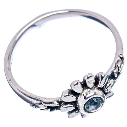 Sterling silver dainty flower ring with blue gemstone on rounded band, side view