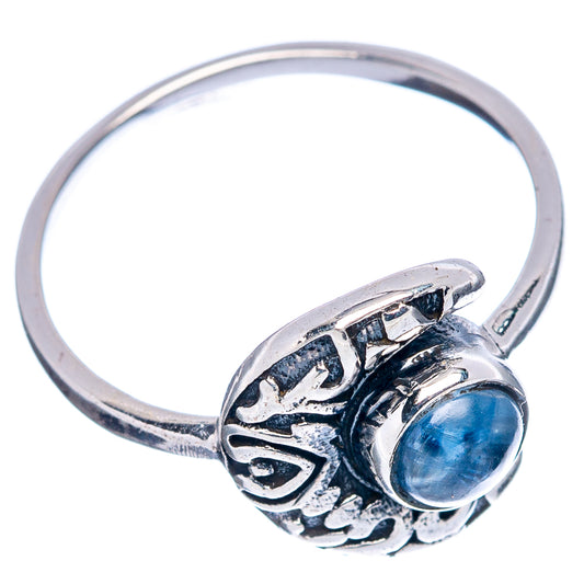 Sterling silver ring with ornate side scrollwork and blue oval cabochon moon setting