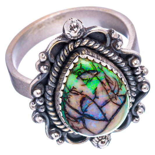 Ornate sterling silver ring with green-blue iridescent oval opal in frame